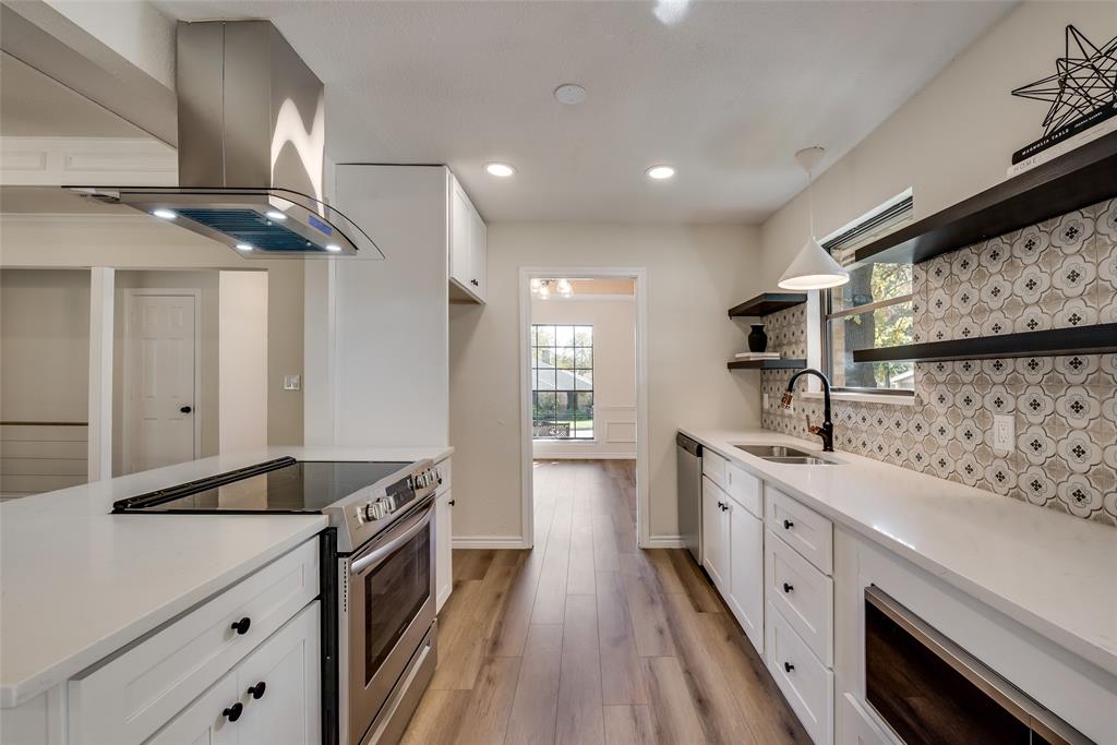 Custom kitchen wall with tall pantry cabinets and styled open shelving