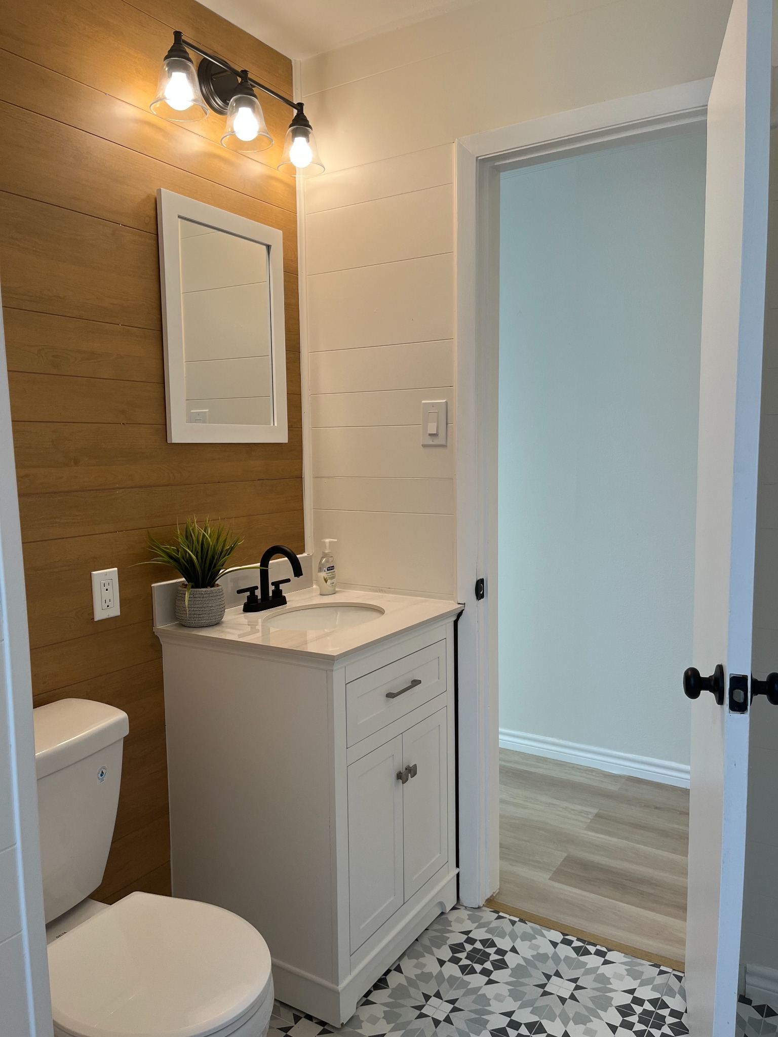 Primary bathroom featuring double vanity and warm finishes